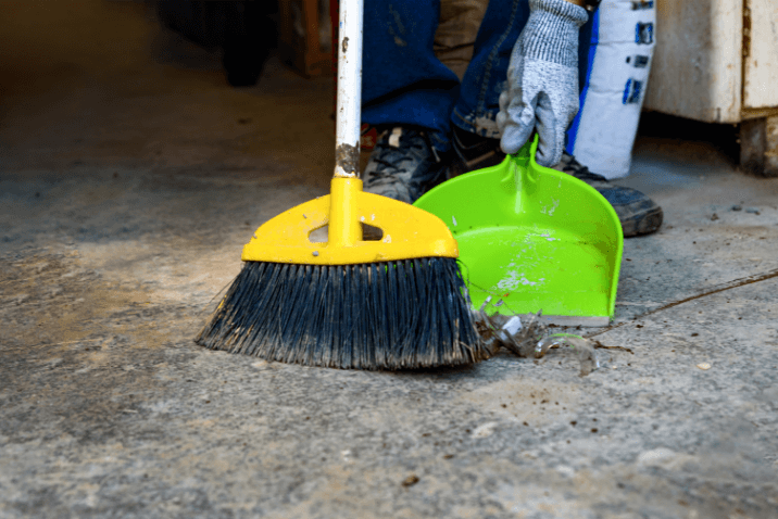 Residential cleaning service with a focus on sweeping and tidying up inside the garage.